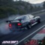 A modified black Japanese racing car is drifting on a track, kicking up smoke. The 
